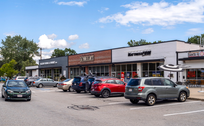 Busy parking lot in front of Mattress Firm and Not Your Average Joe's restaurant.