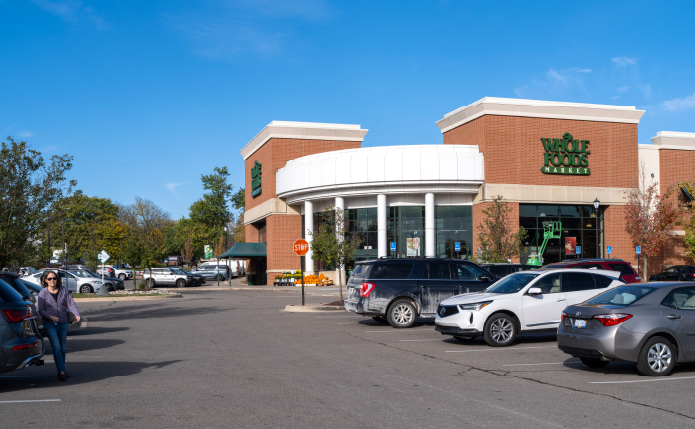 Whole Foods Market with busy parking lot.