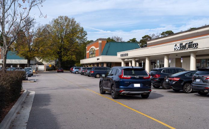 SUV passing lot at FedEx Office in Raleigh.