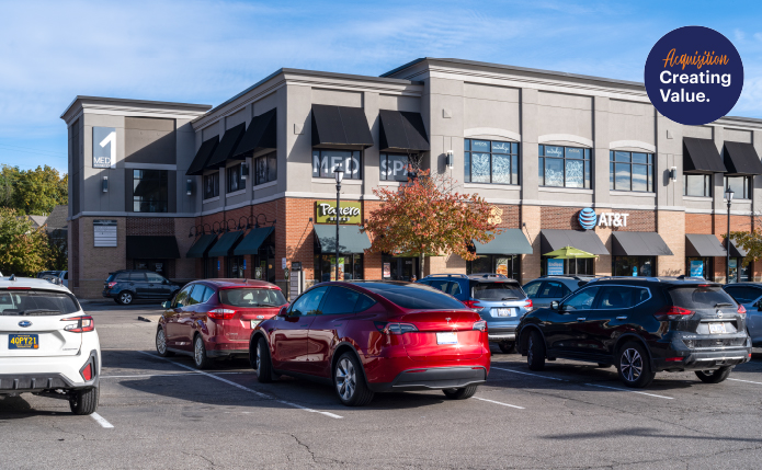 Busy parking lot in front of AT&T in shopping center.