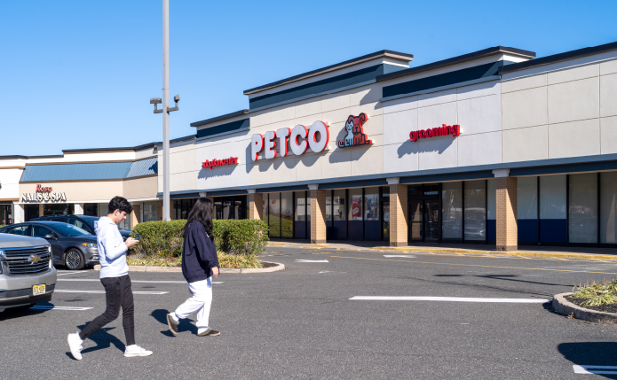 2 people approach Petco store in a parking lot.