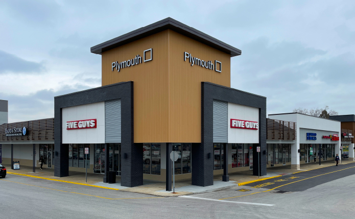 Corner building at Plymouth Square shopping center with Five Guys storefront.