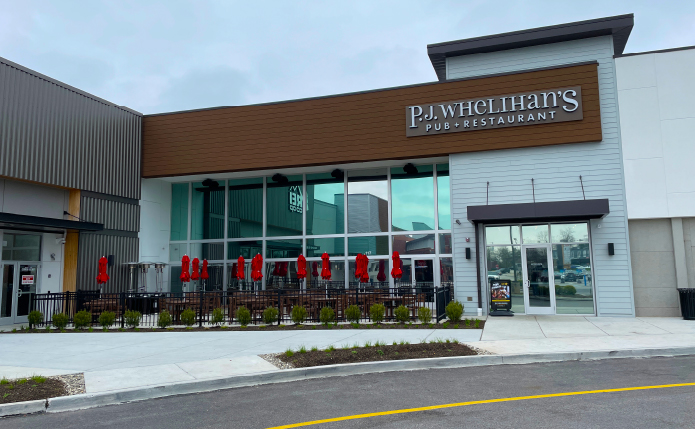 P.J. Whelihan's Restaurant with outdoor seating and closed red umbrellas.