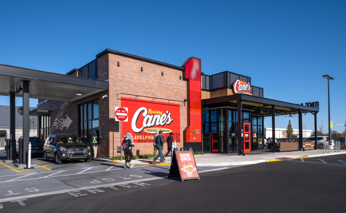 Drive-thru and customers in front of Raising Cane's.