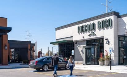 Piccolo Buco restaurant at Block 59 in Naperville, IL highlighting repositioned retail space, refreshed façades, and walkable site design as part of the completed mixed‑use redevelopment.