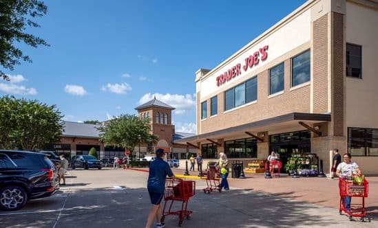 Patrons with shopping carts enter and exit Trader Joe's at LaCenterra at Cinco Ranch.