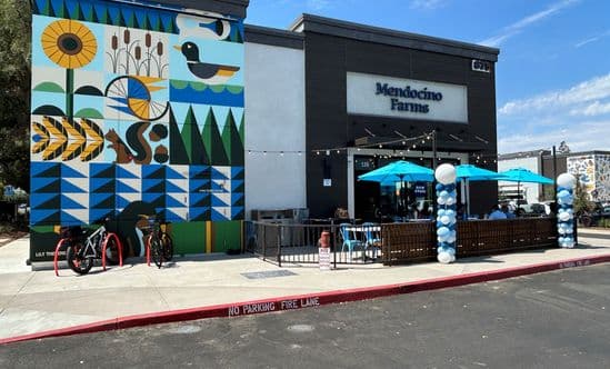 Colorful mural on building next to Mendocino Farms restaurant