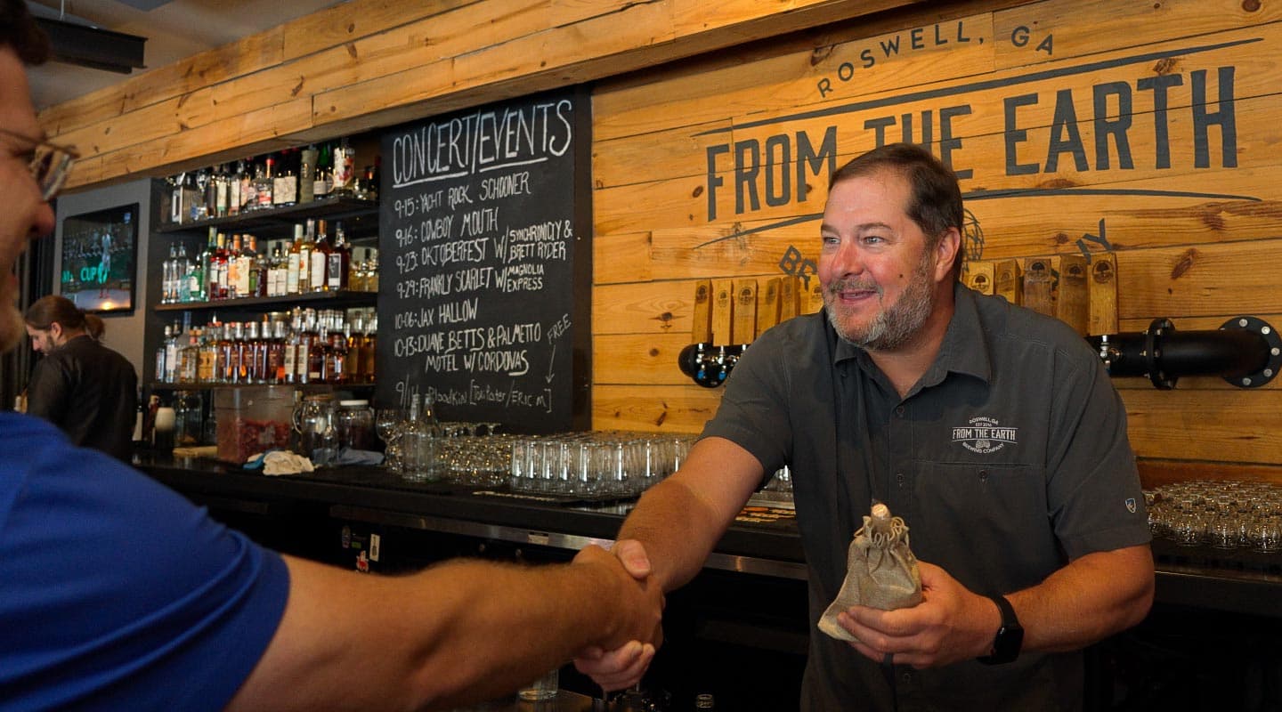 Restaurant owner shaking hands with someone offscreen