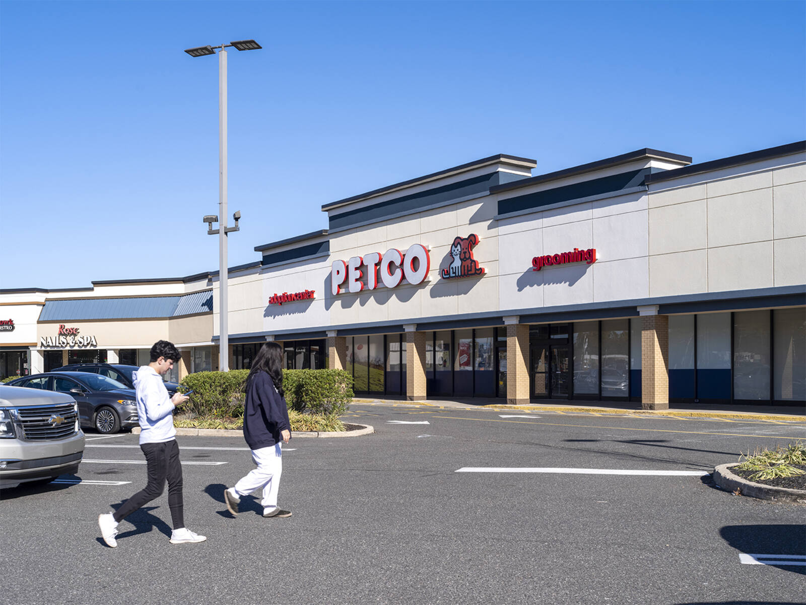 Two people entering Petco in Middletown, NJ.
