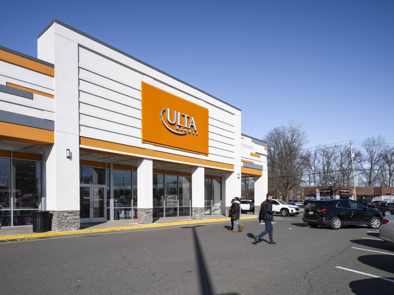 Ulta Beauty with two patrons exiting into parking lot.