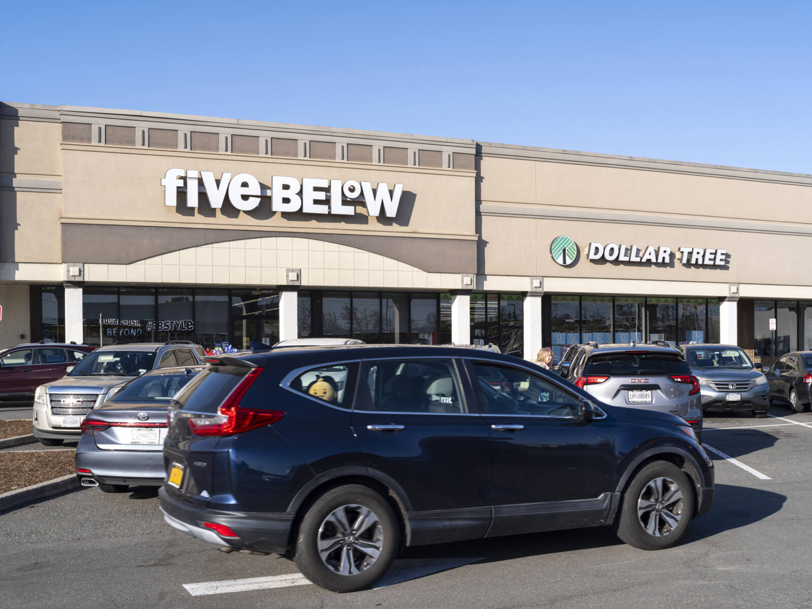 Busy parking lot at Five Below and Dollar Tree.
