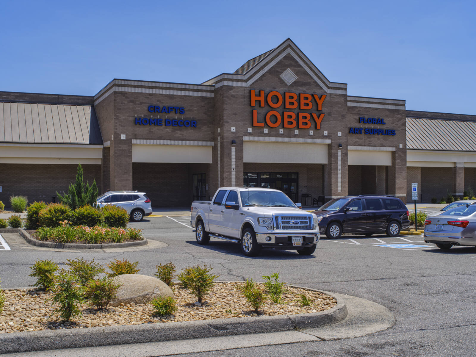 White truck exiting Hobby Lobby craft store at Hanover Square.