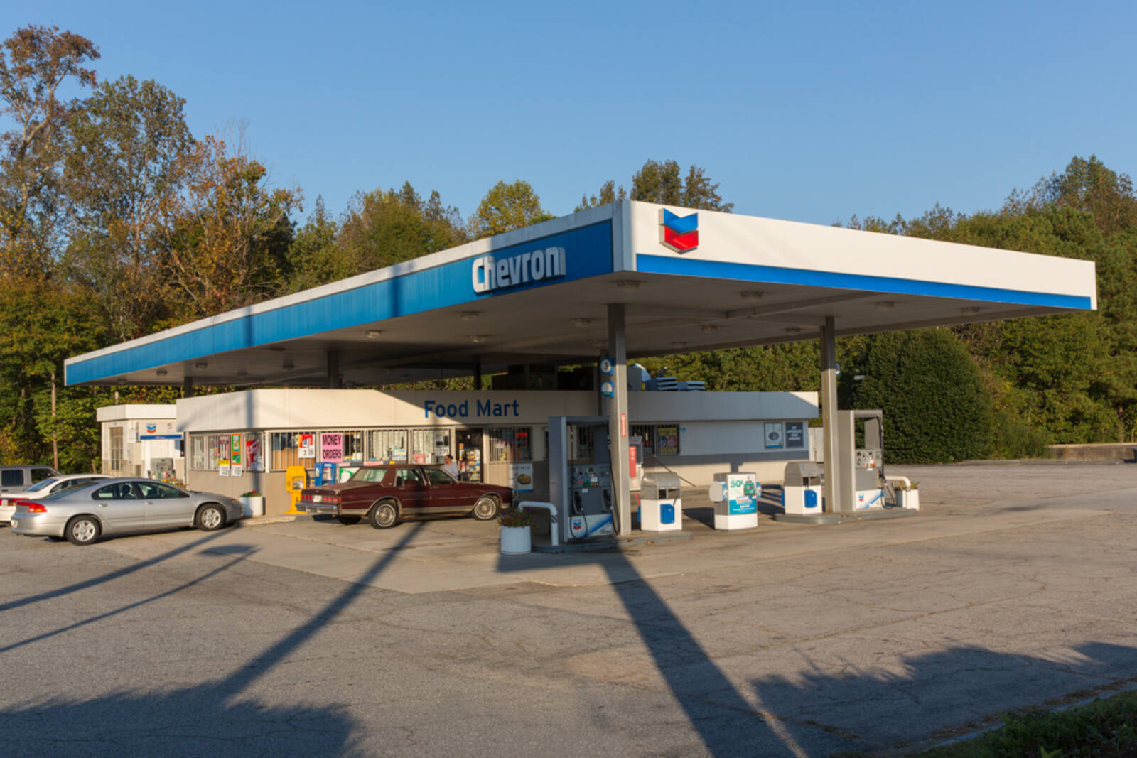 Two cars entering drive thru of Chevron