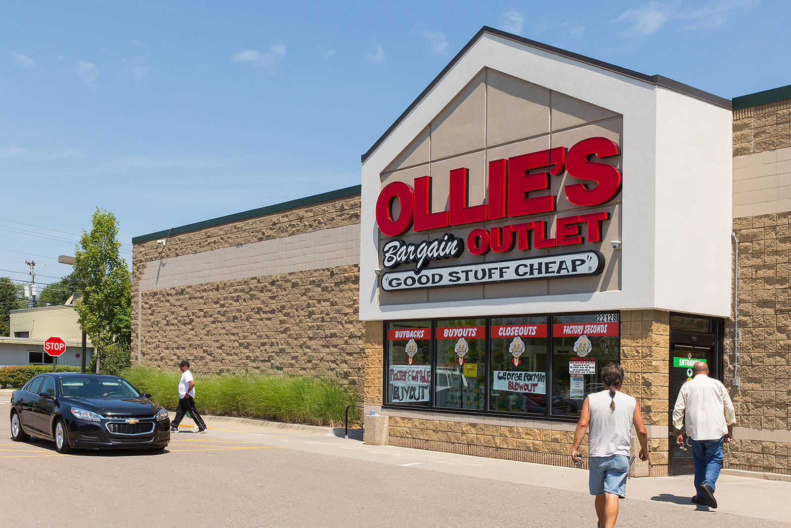 Two shoppers enter Ollie's Bargain Outlet at Farmington Crossroads.