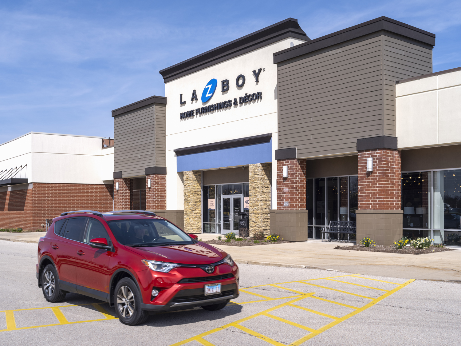 Red SUV parked in front of LaZBoy store