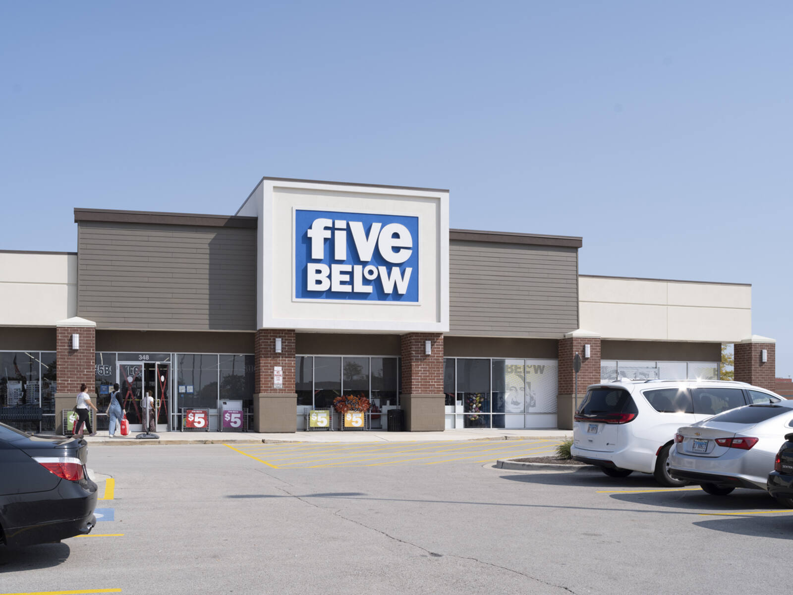 Two customers enter Five Below store.