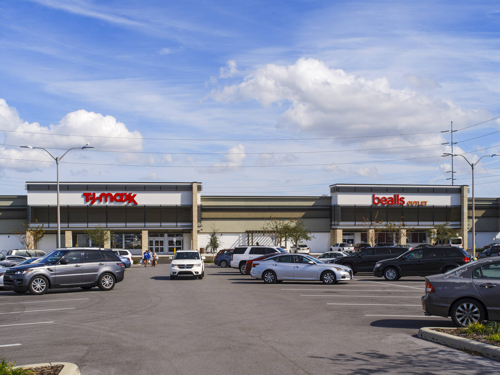 Full parking lot at shopping center with T.J. Maxx and Bealls