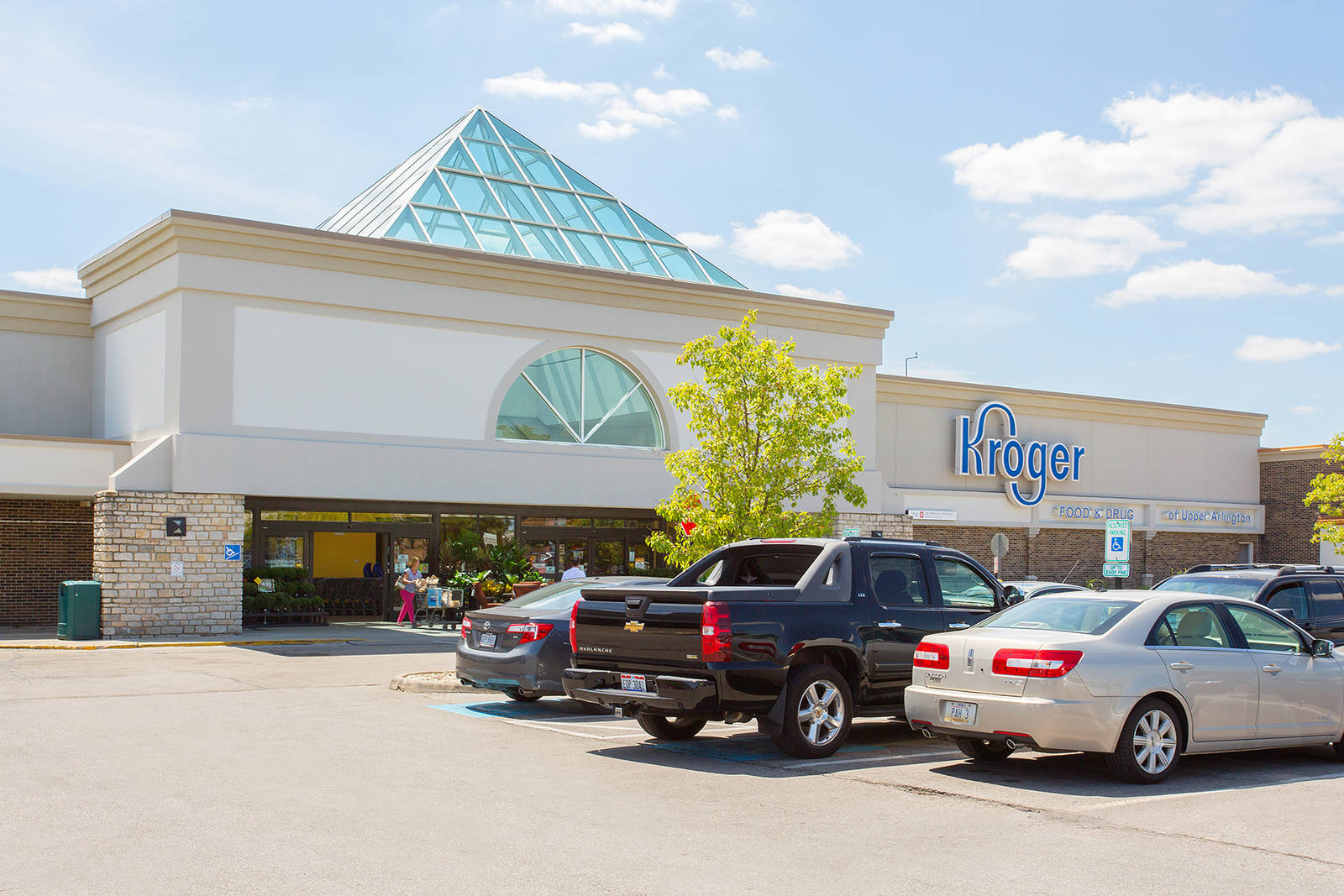 Kroger marketplace parking lot with small tree and cars in Greeneville, TN.