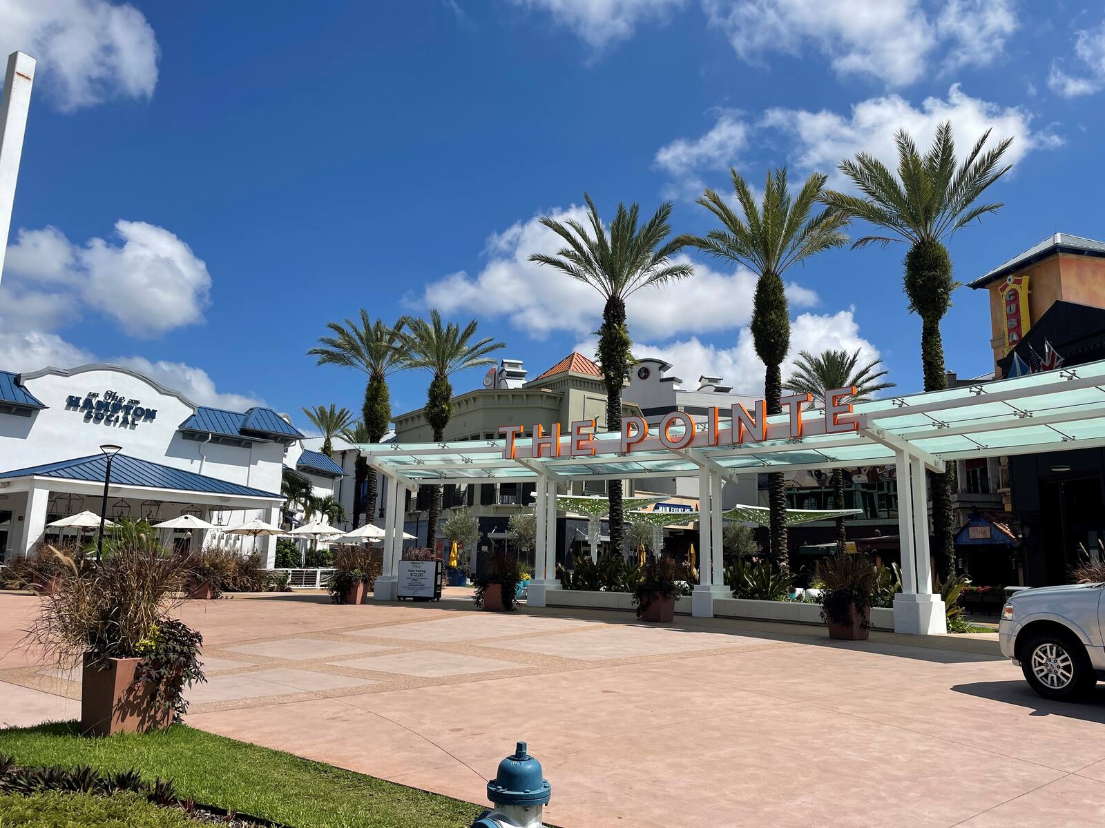 Palm trees and blue skies over the Pointe entrance in Orlando, FL.