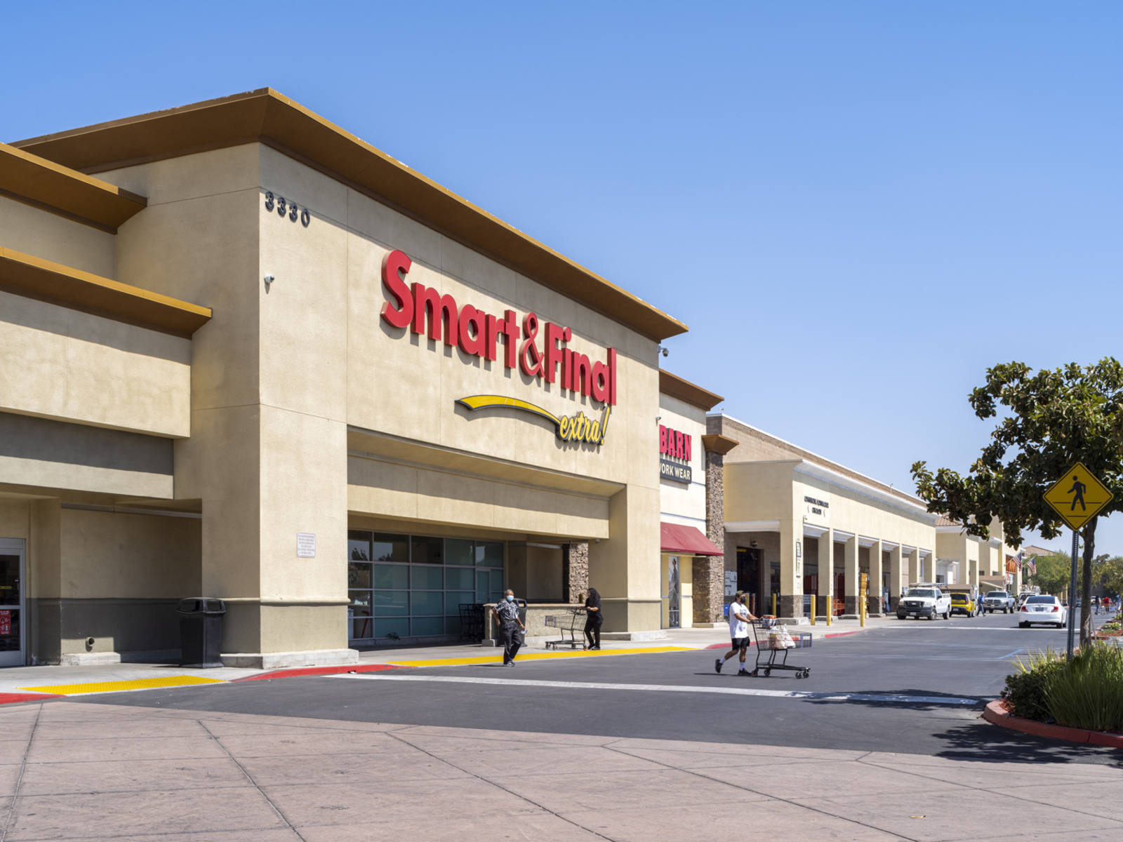 Shoppers enter and exit Smart & Final in Fresno, CA.