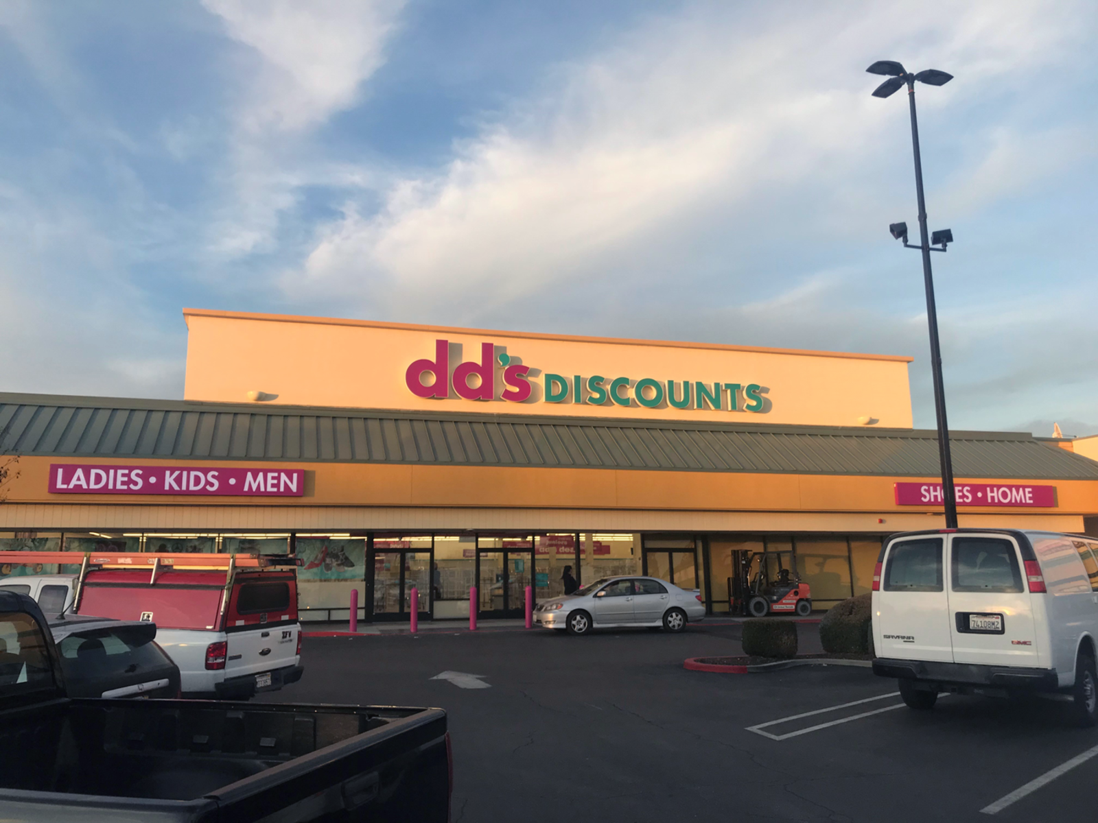 Grey car parked in front of dd's Discounts in Modesto, CA.