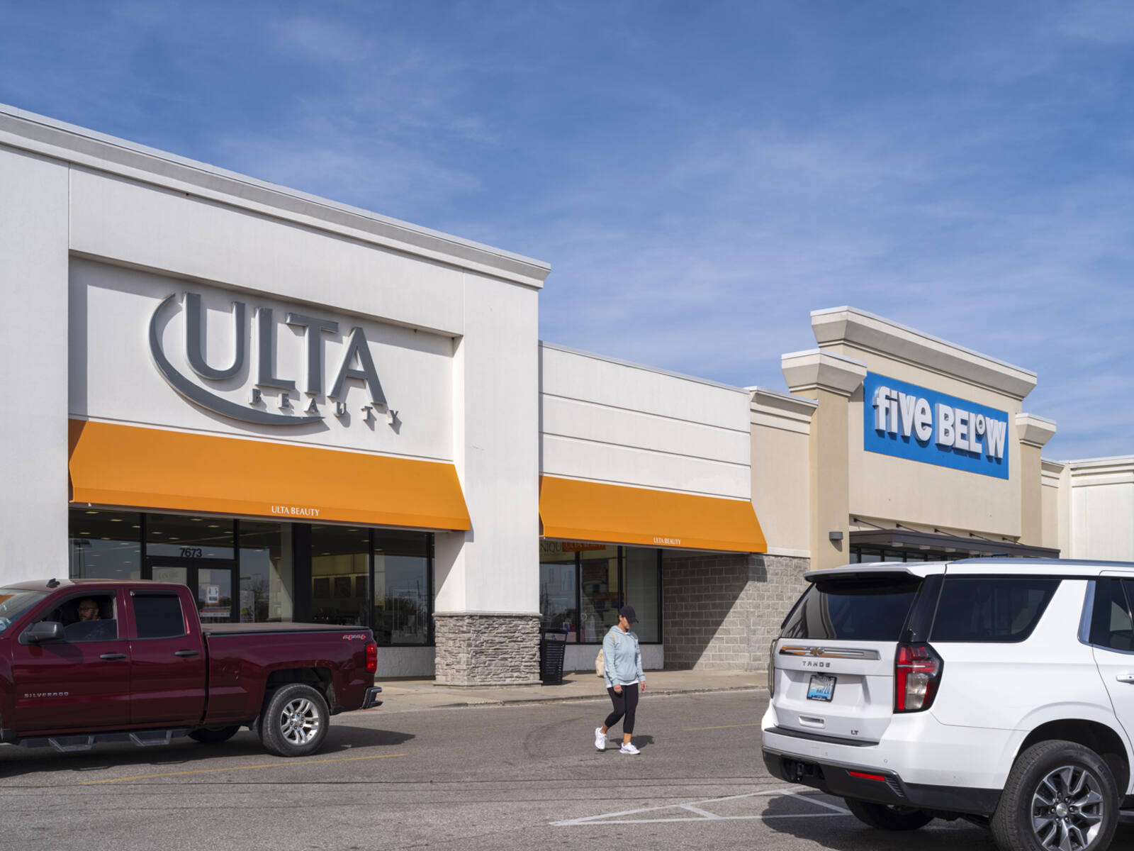 Woman exits Ulta Beauty into road with a Truck and SUV.