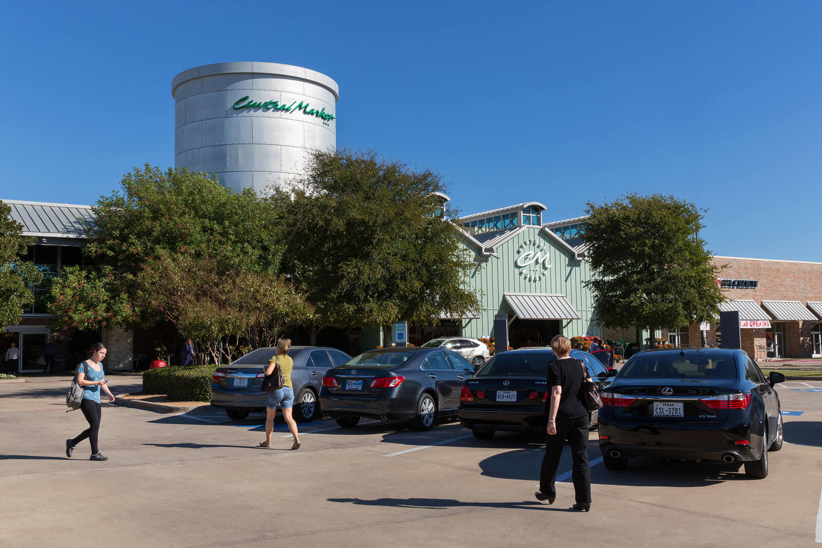 Women pedestrians in parking lot of Central Market in Plano, TX.