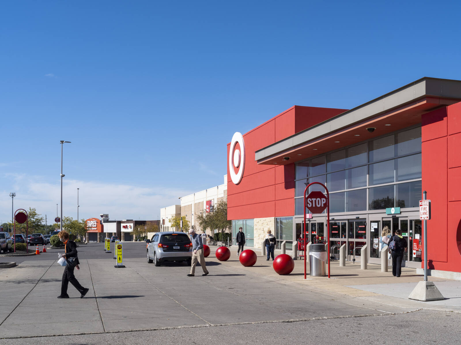 Multiple people entering and exiting Target on a clear day in Cincinnati, Ohio