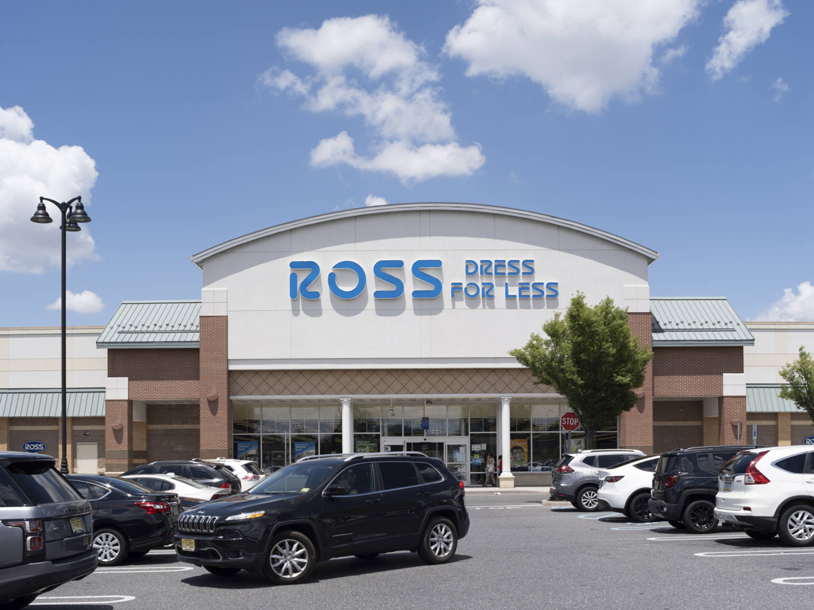 Black SUV turning right in a full parking lot of Ross Dress For Less