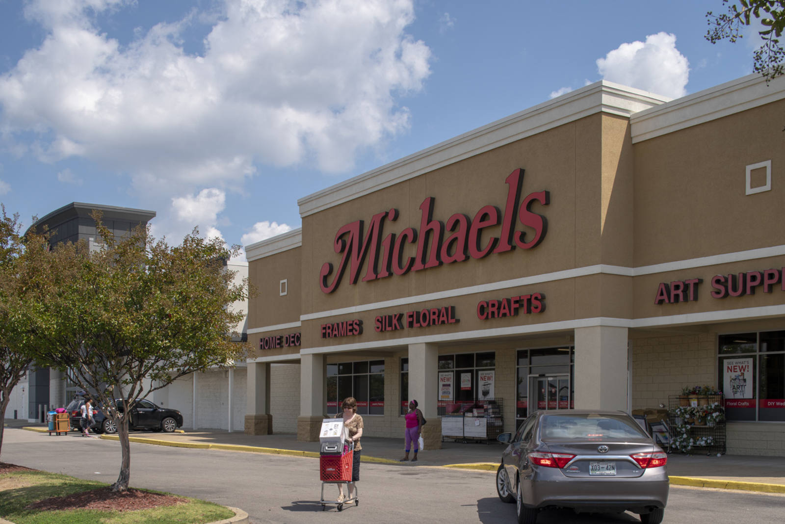 Customer with cart leaving Michaels arts and crafts store in Memphis, TN.