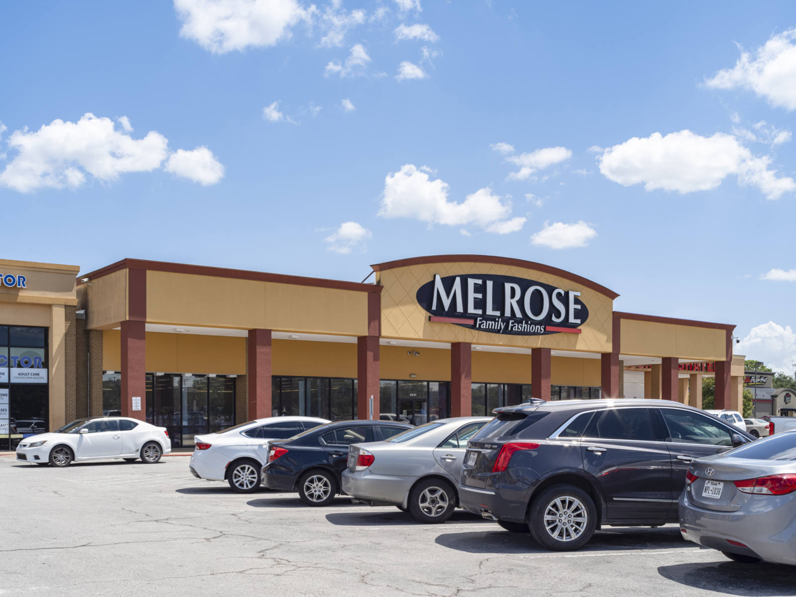 Cars line the parking at Melrose Family Fashions department store at Broadway shopping center.