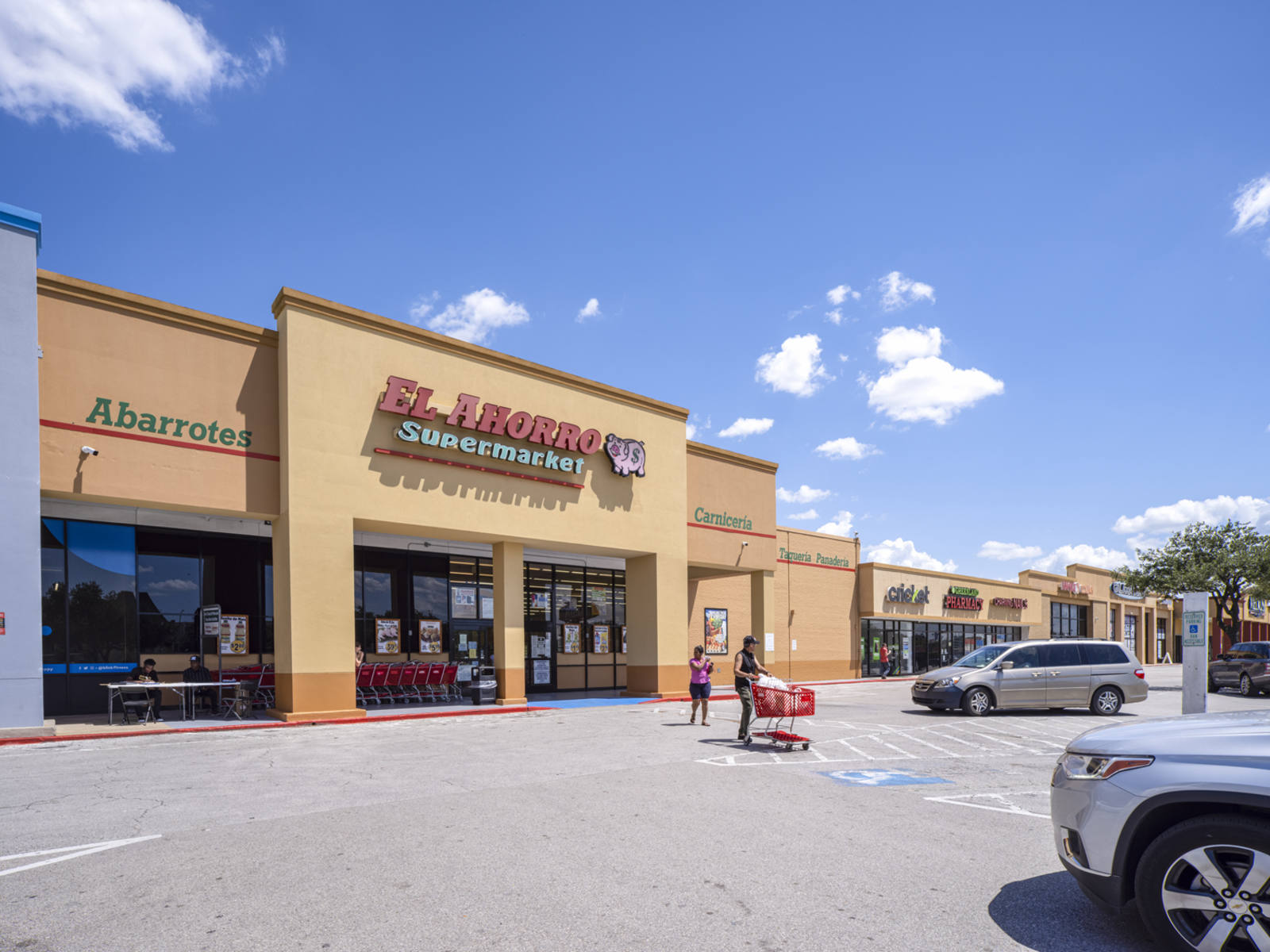 Two shoppers exit an El Ahorro supermarket in Houston, TX.