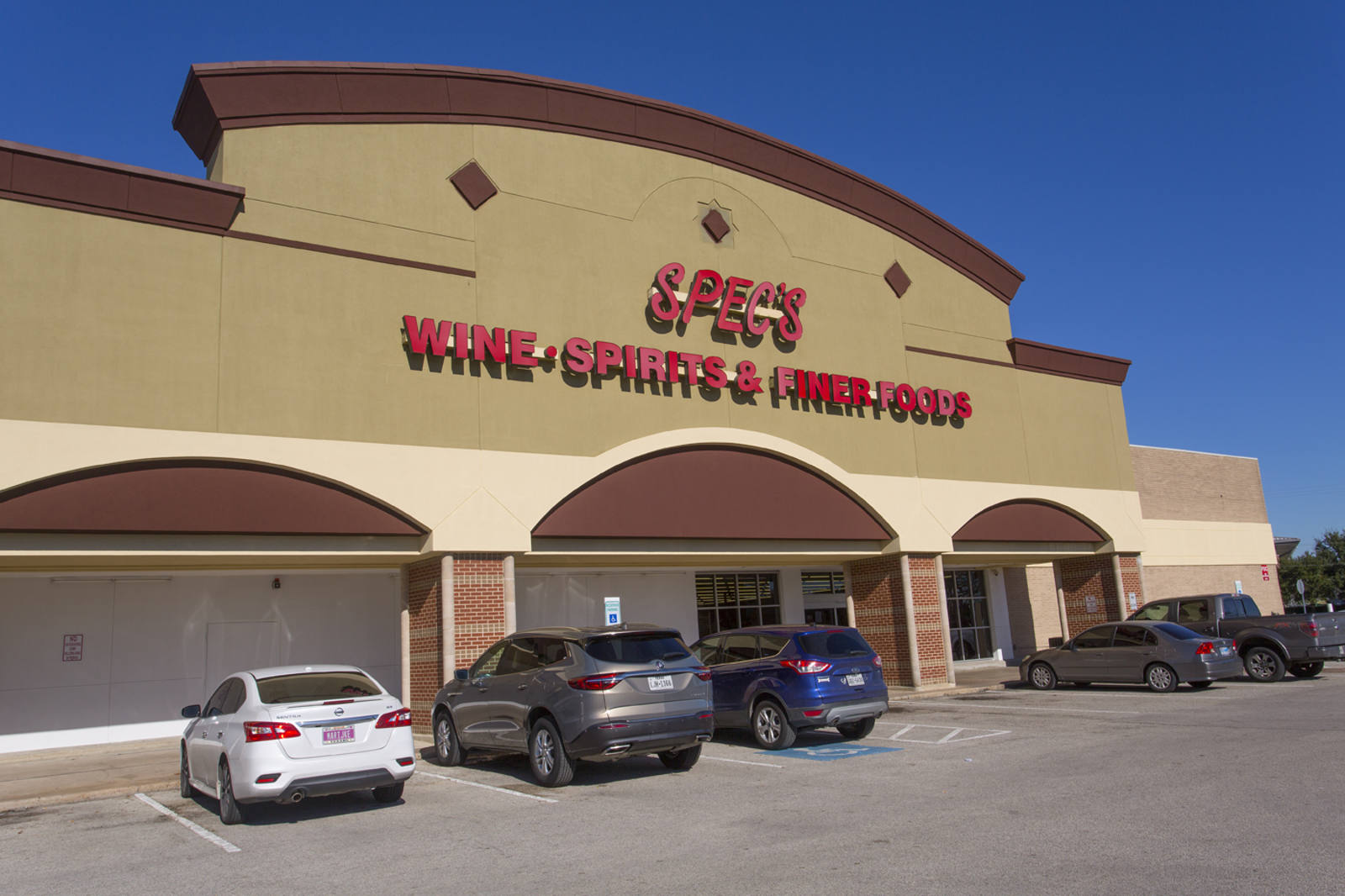 Parking lot and entrance of Spec's wine and spirit store at Clear Lake Camino South.
