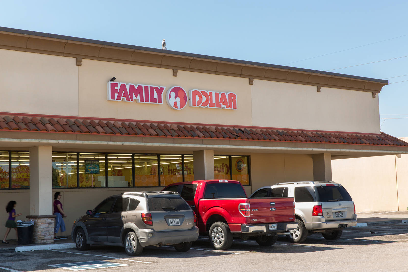 Customers exiting to parking lot at Family Dollar store in El Camino shopping center.