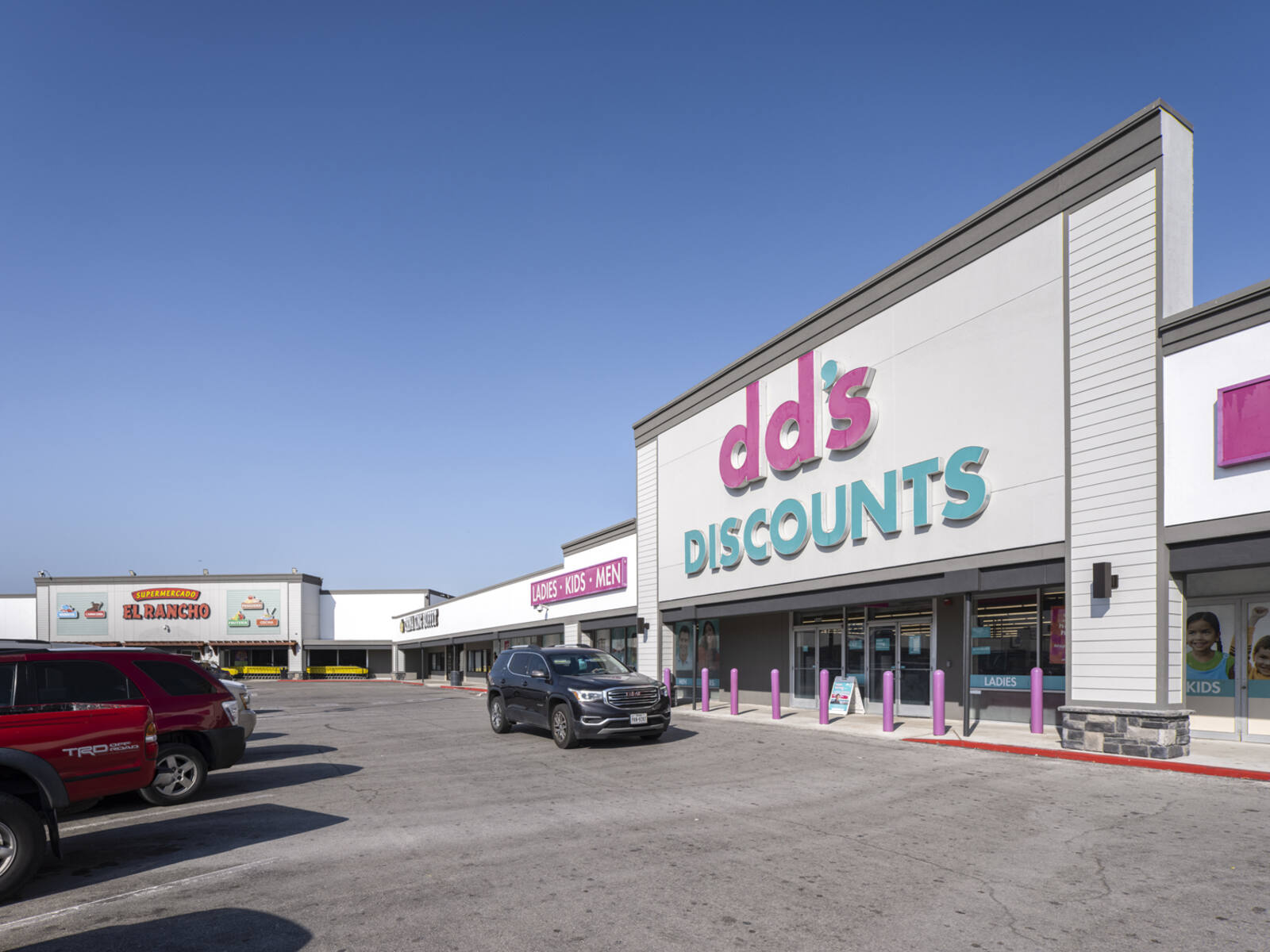 dd's Discounts store with Black SUV parked in front.