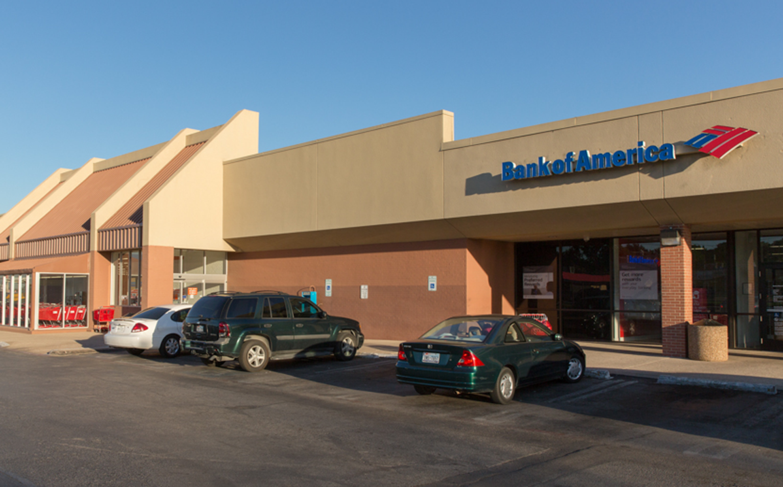 Cars parked in front of Bank of America at Stevens Park Village Shopping Center.