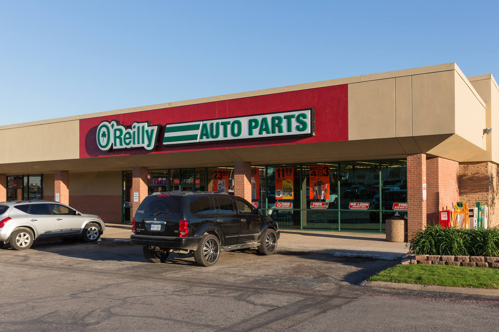 Black car parked in front of O'Reilly Auto Parts