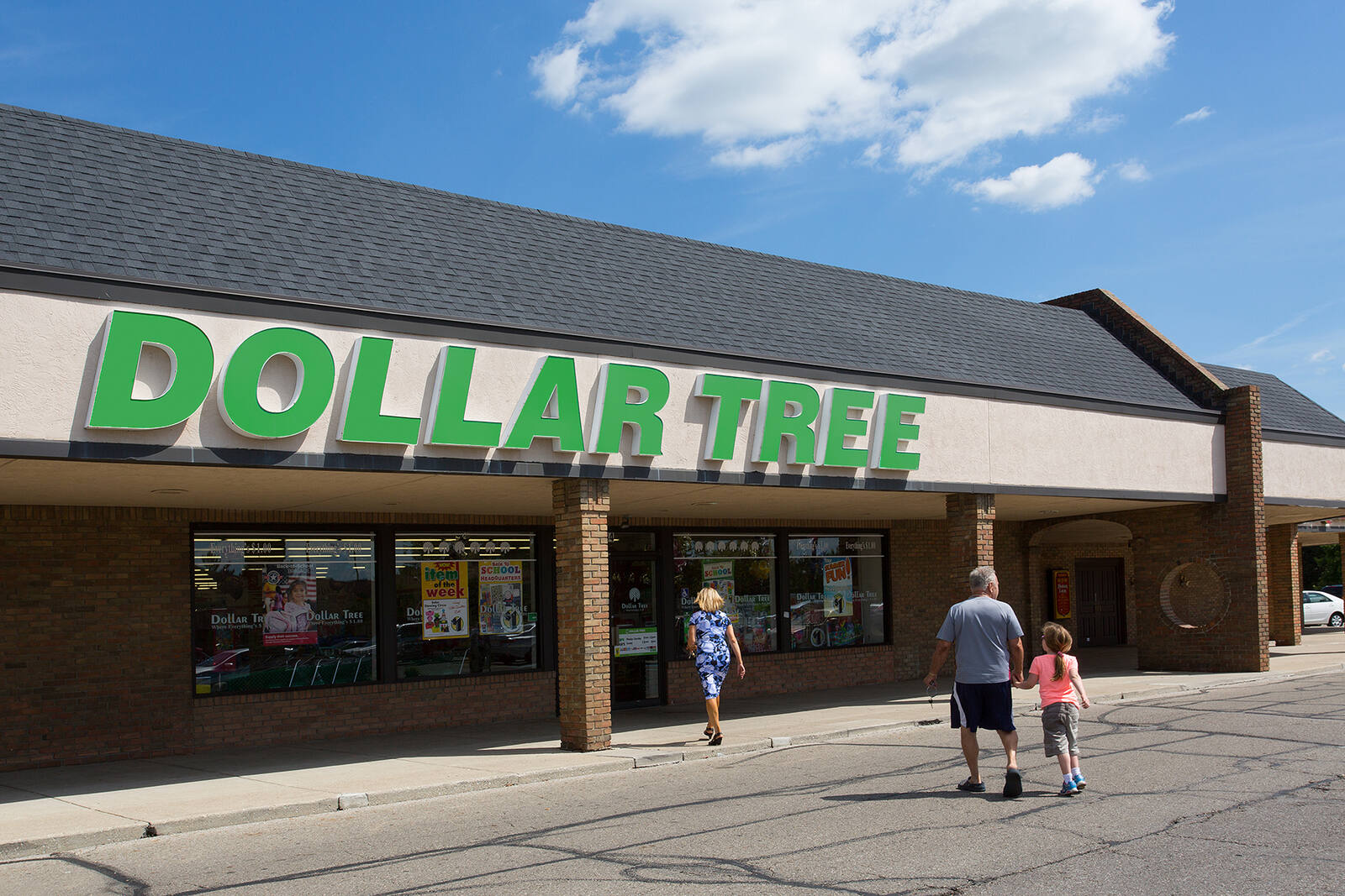 A woman, man and child enter Dollar Tree store at Crown Point shopping center.