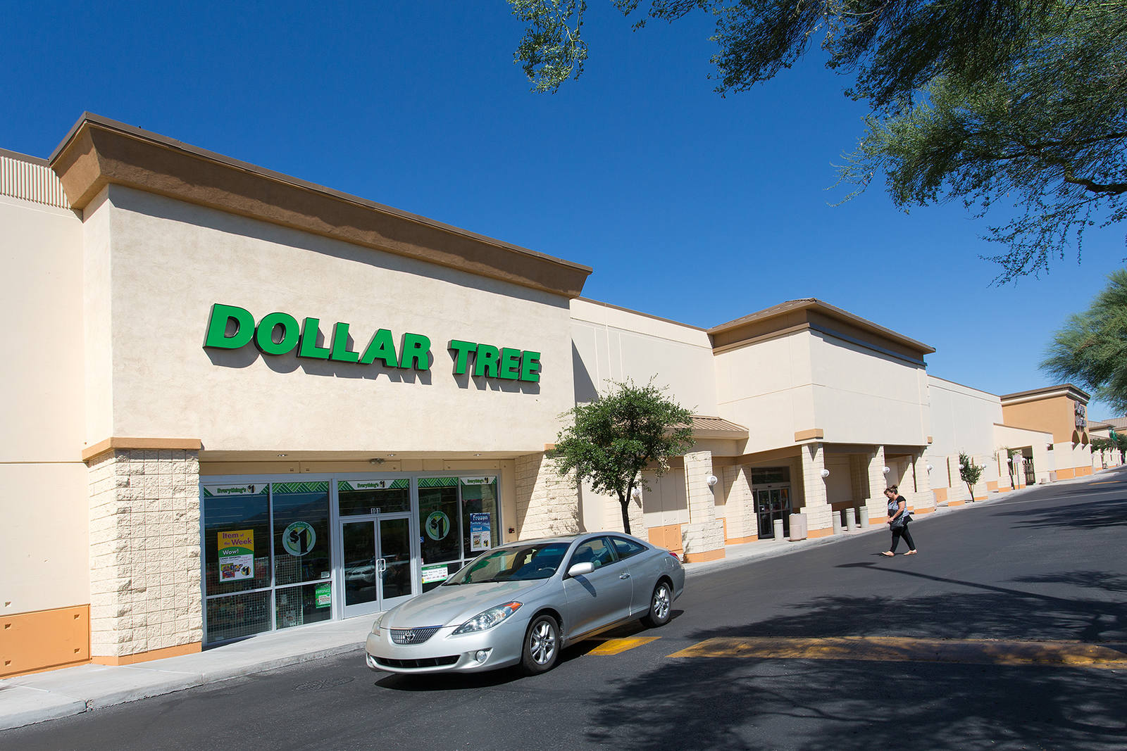 Silver car passing in front of Dollar Tree at Northmall Centre