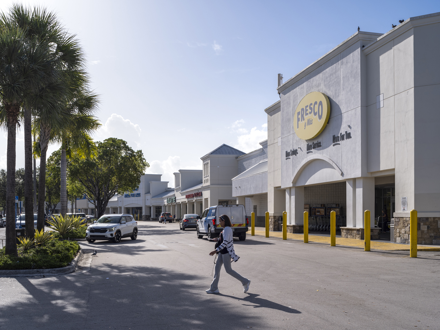 Woman crossed road in front of Fresco Y Mas supermarket.