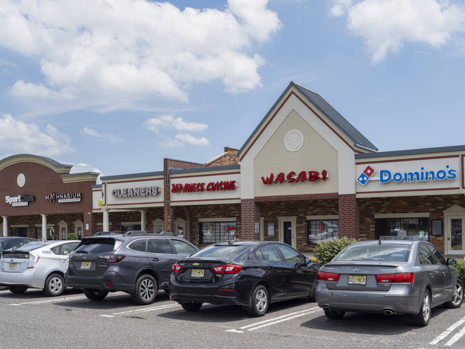 Busy parking lot at Domino's pizza and inline shops in Mount Laurel, NJ.