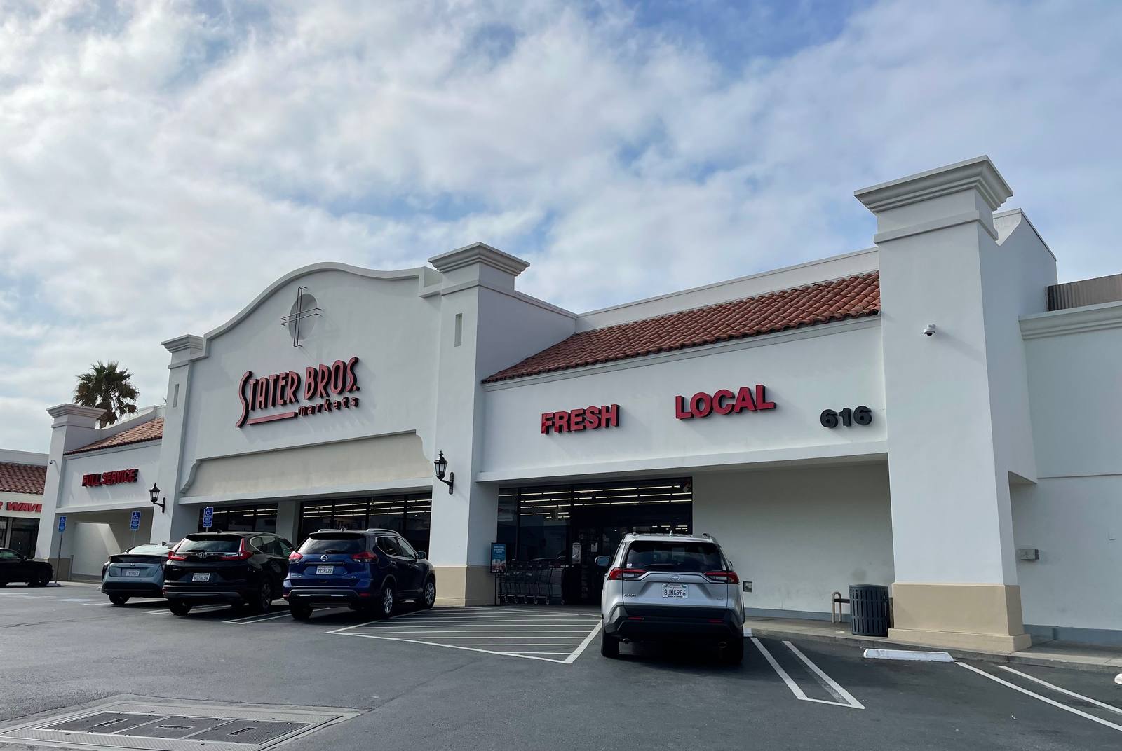 Cars parked along entrance of State Bros. at Plaza by the Sea shopping center