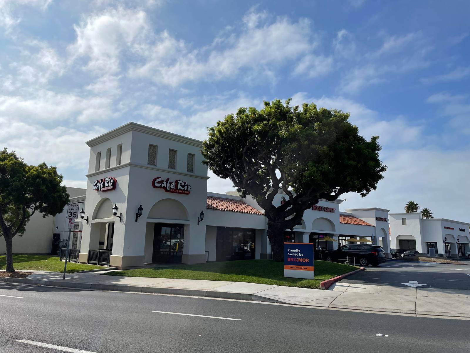 Large green tree in front of entrance of Cafe Rio in San Clemente, California