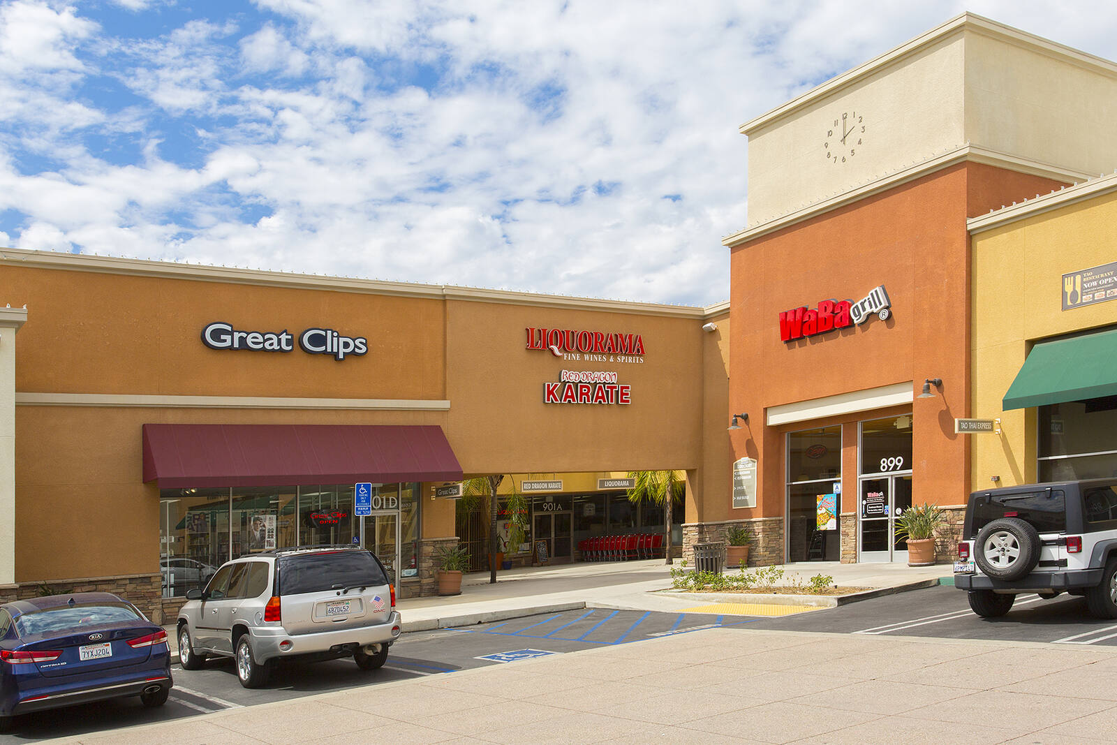 Corner of small shops at Upland Town Square with cars parked in front