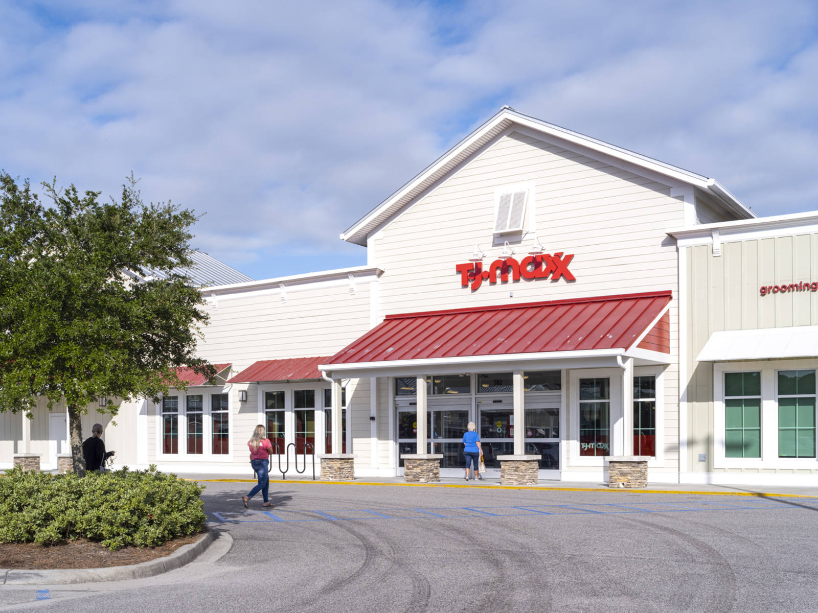 Trees on left side of entrance to T.J. Maxx with red awning