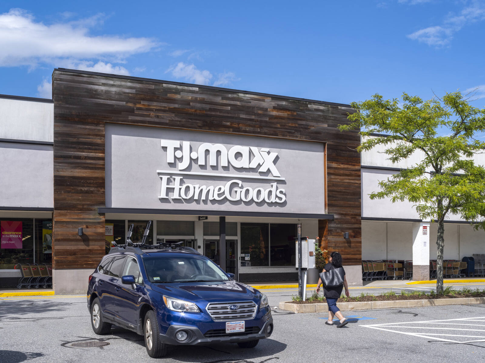 Woman and blue SUV at TJ Maxx HomeGoods storefront.