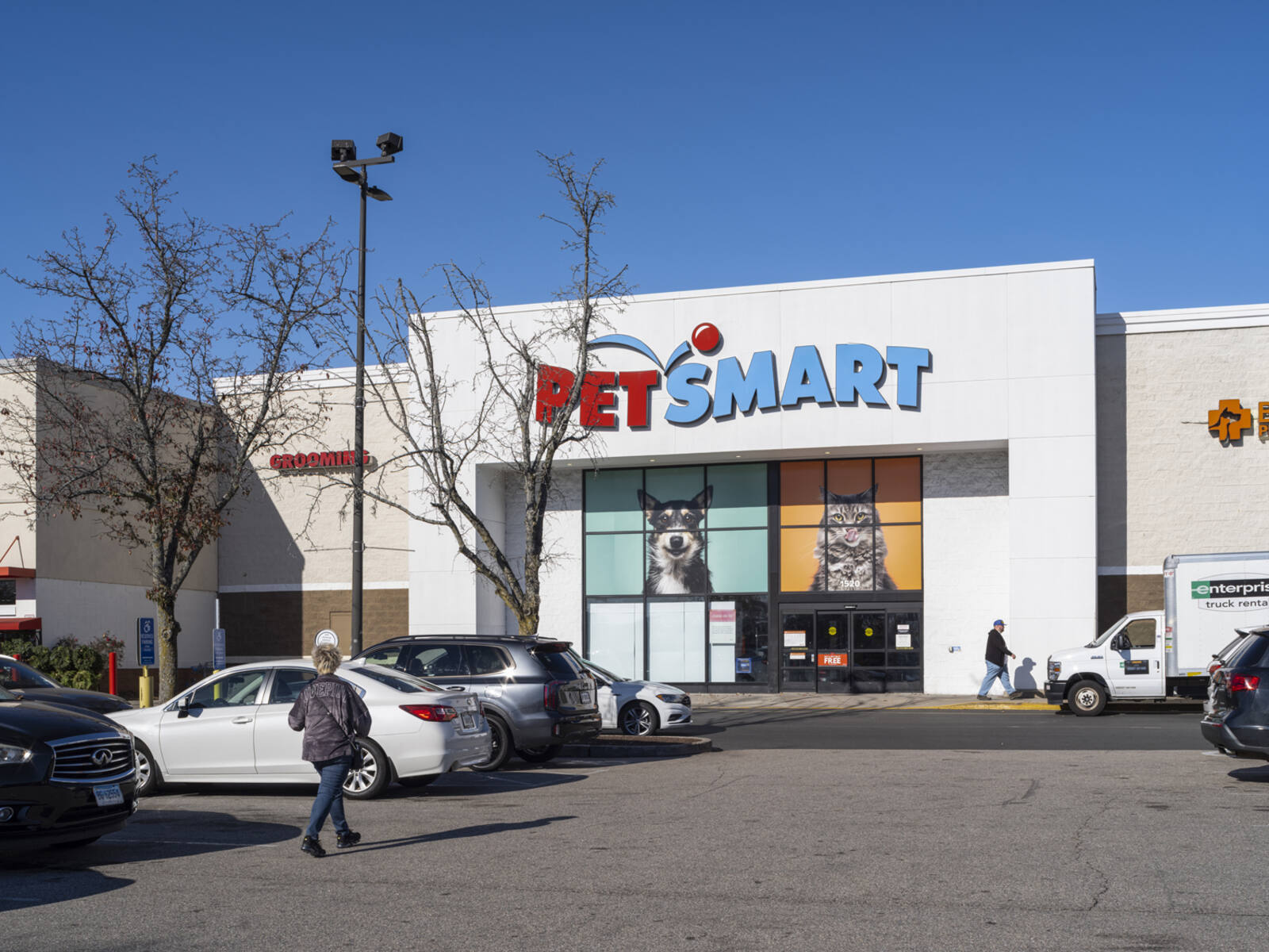 Customer approaches PetSmart via an aisle in parking lot.