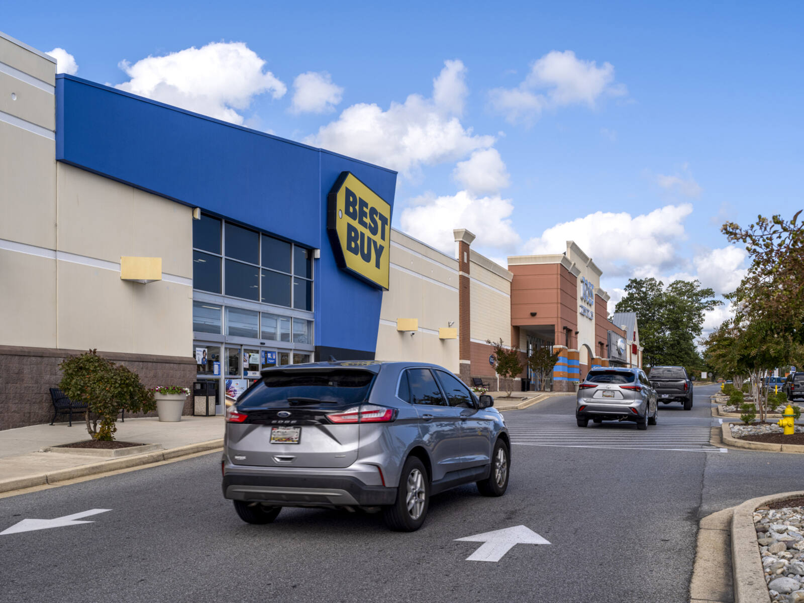 Busy access road between Best Buy and parking lot.