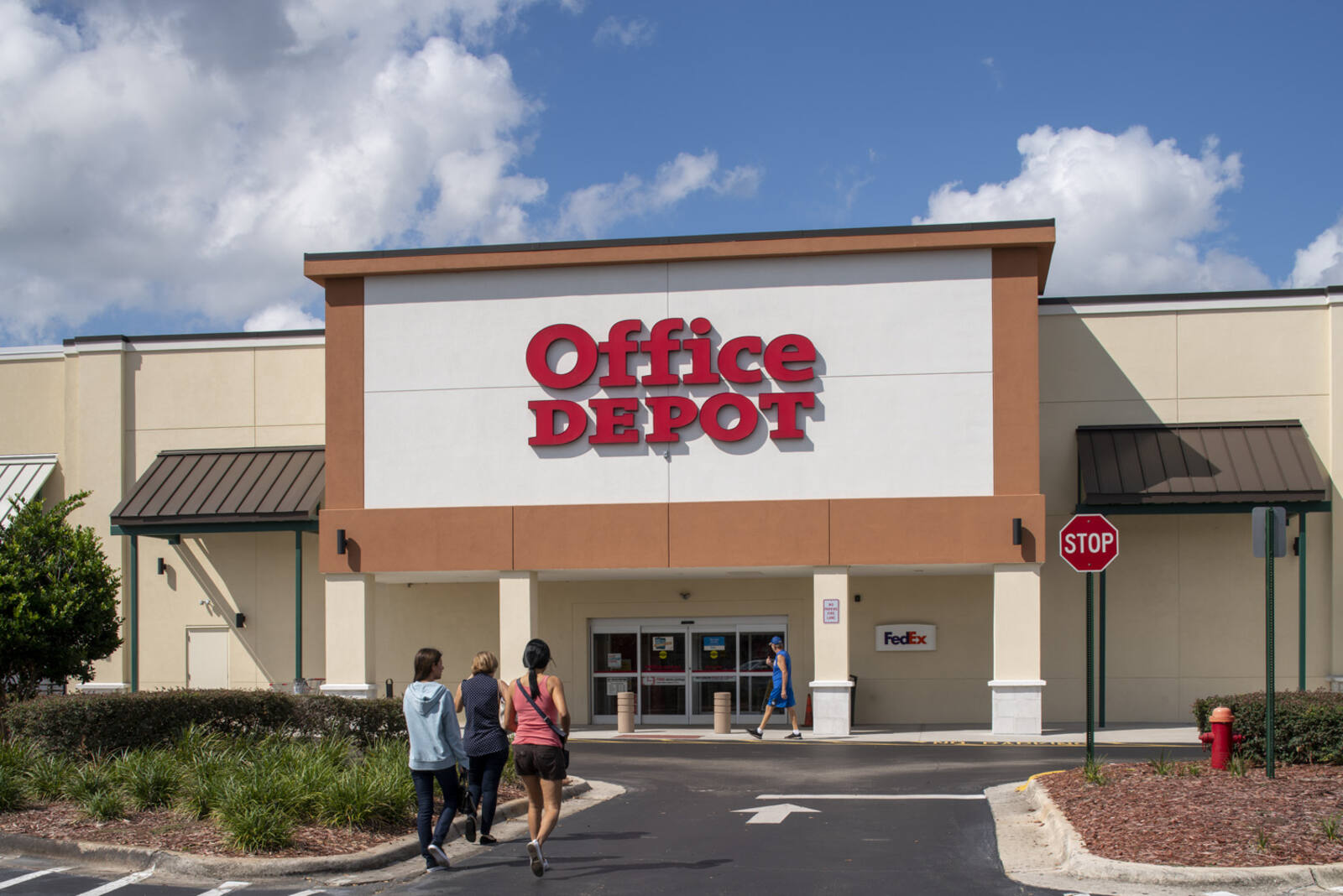 Women entering Office Depot with planters in Orlando, FL.
