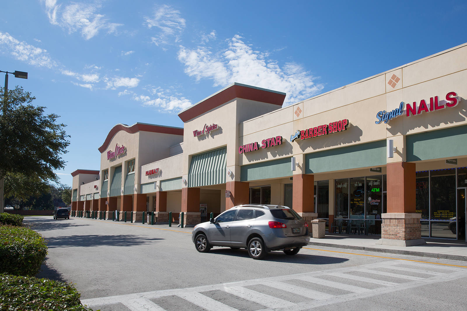 Grey SUV passing crosswalk at Lake St. Charles.